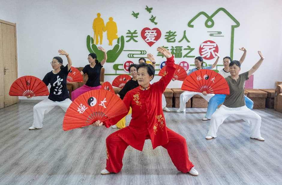 在江苏省兴化市昭阳街道英武社区居家养老服务站，老年人们在学习太极功夫扇。来源：人民图片